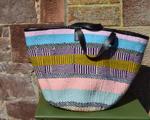 Giant Woollen Kiondo Style Lined Basket with heavy duty Mocha leather trim & handles. Pink, Blue and Black and Yellow Patterned Hoops