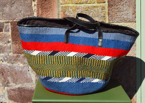 Giant Woollen Kiondo Style Lined Basket with heavy duty Mocha leather trim & handles. Dark Blue, Red and Beige and Green Patterned Hoops